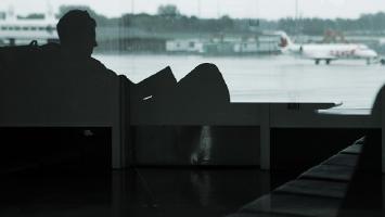 featured_layover-man-in-airport-aaron-pate.jpg Video Thumbnail